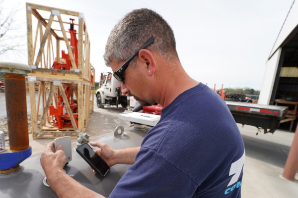 Tevis Energy professional examining heating oil tank