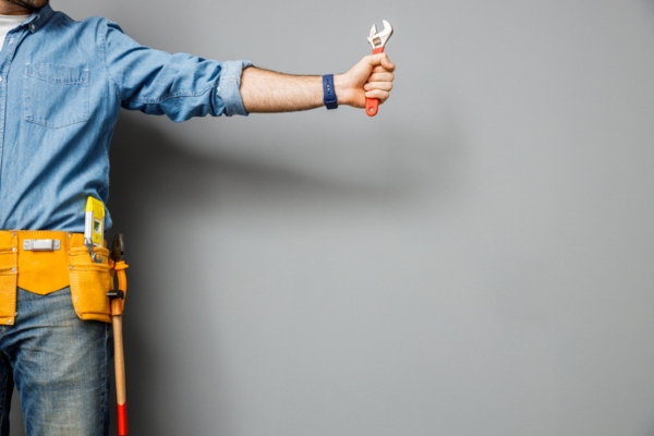 cropped photo of handyman with tools depicting professional standby generator installation