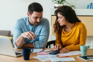 couple looking at energy bill depicting ways to reduce heating bills