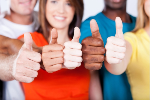 cropped and out of focus image of 5 different people making a thumbs up depicting making the right choice for fuel oil delivery