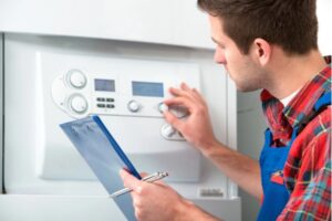 technician servicing residential boiler due to poor water system quality