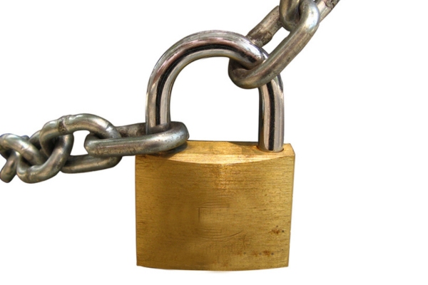 Key lock locked with a chain depicting securing construction fuel supply