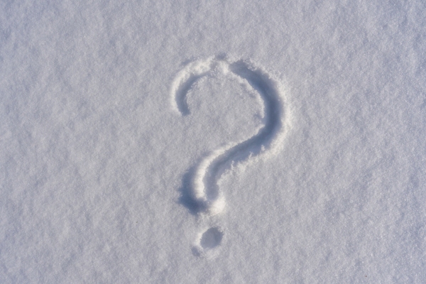 question mark written on snow depicting questions about heating oil preparation tips