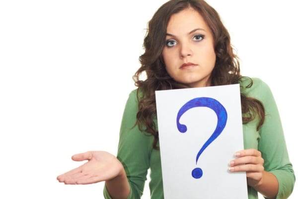 woman holding a question mark sign depicting FAQs about proper heater ventilation