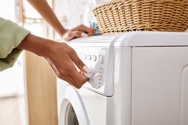 woman taking clothes out of clothes dryer